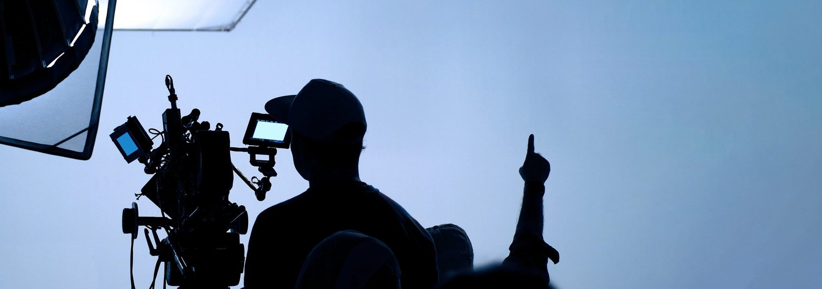 Film production crew setting up a professional camera